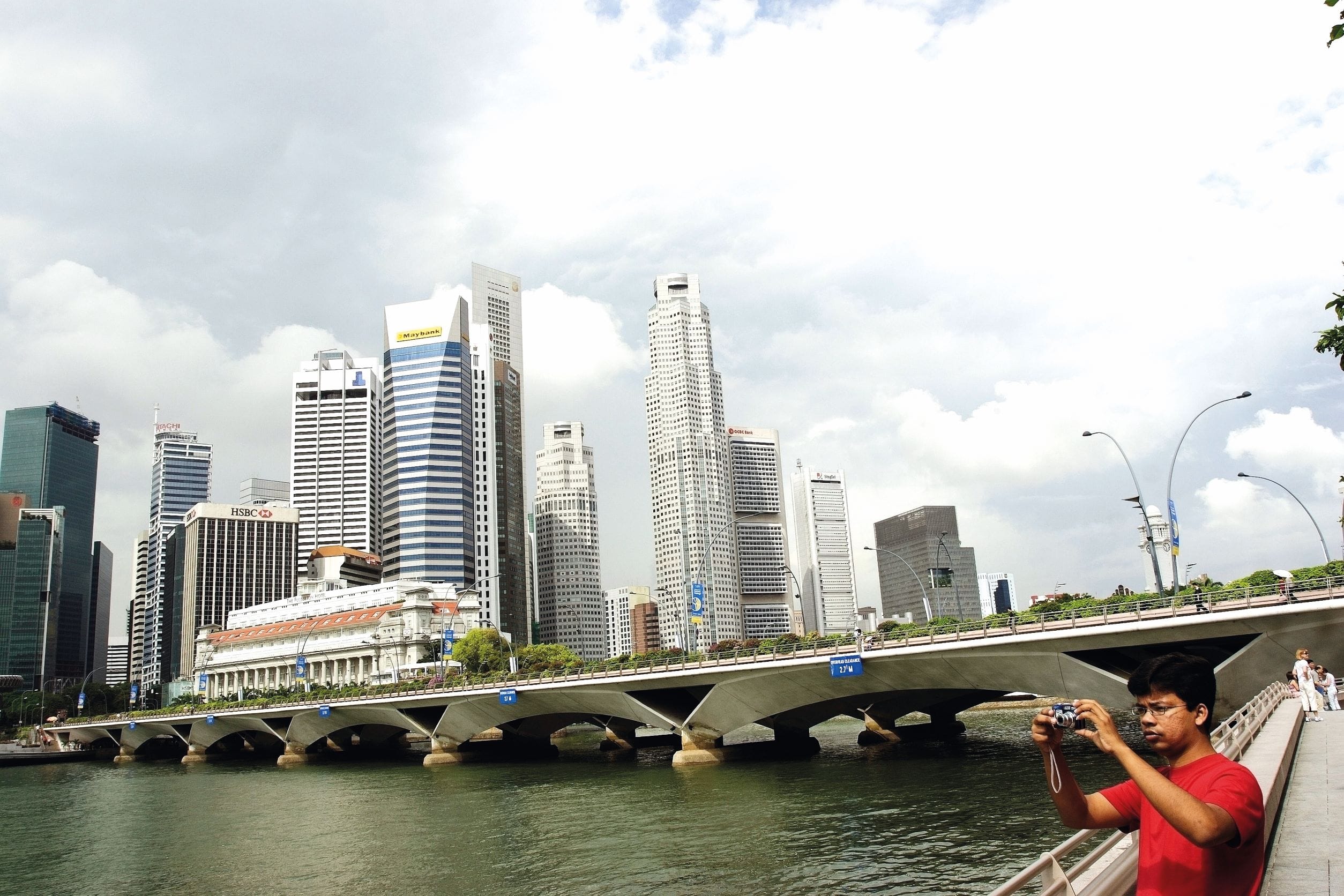Figure 3: On a bridge crossing the Singapore River in the Marina Bay district, tourists walk along to view the skyline in the distance, 2006. ©Luke duggleby/OnAsia.com.